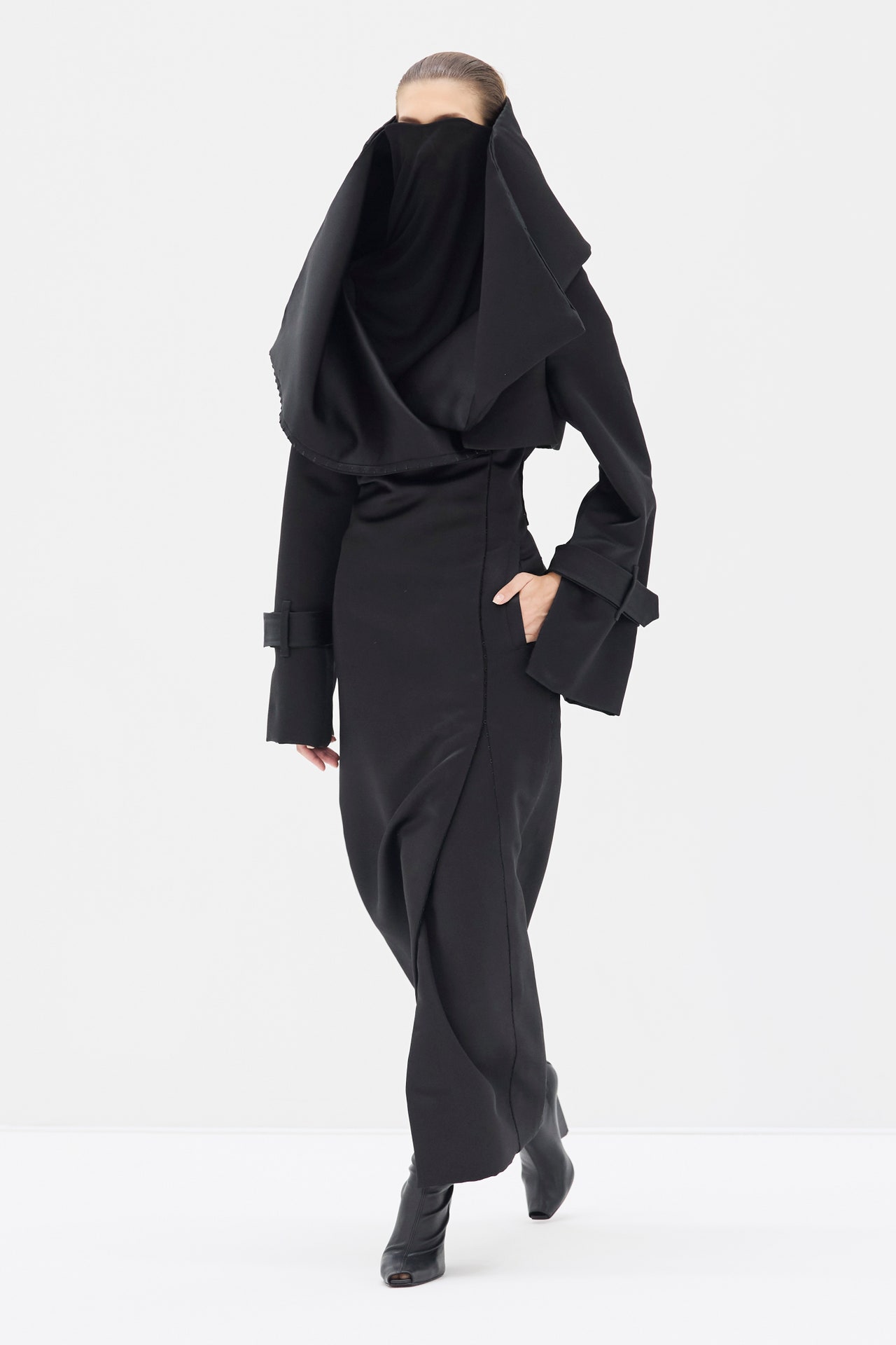 Image may contain Clothing Long Sleeve Sleeve Fashion Formal Wear Suit Adult Person Coat and Walking