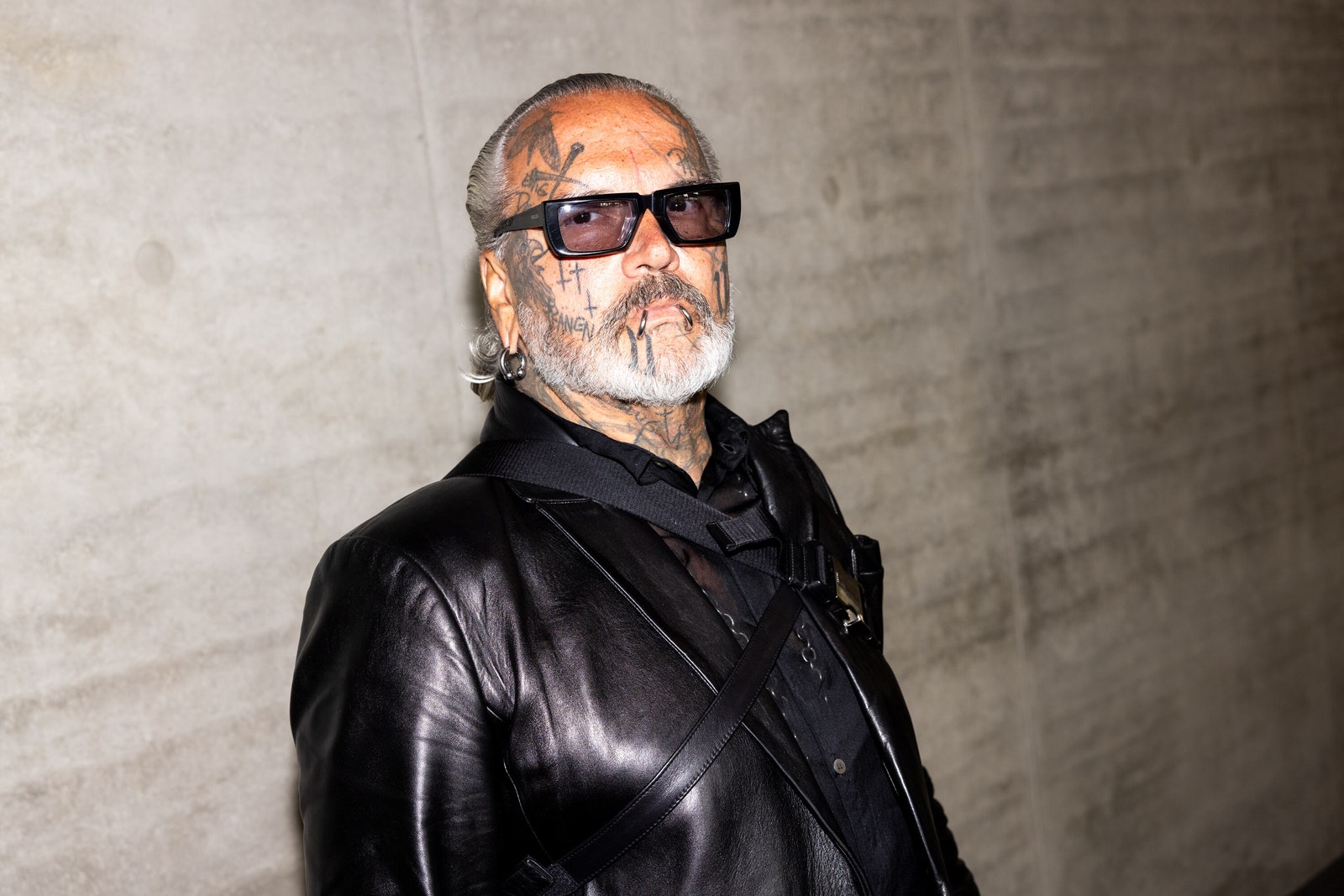 Image may contain Clothing Coat Jacket Face Head Person Photography Portrait Adult Accessories and Glasses